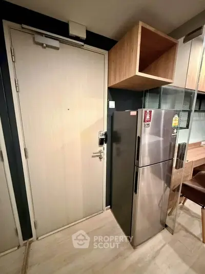 Modern kitchen with stainless steel fridge and wooden cabinetry