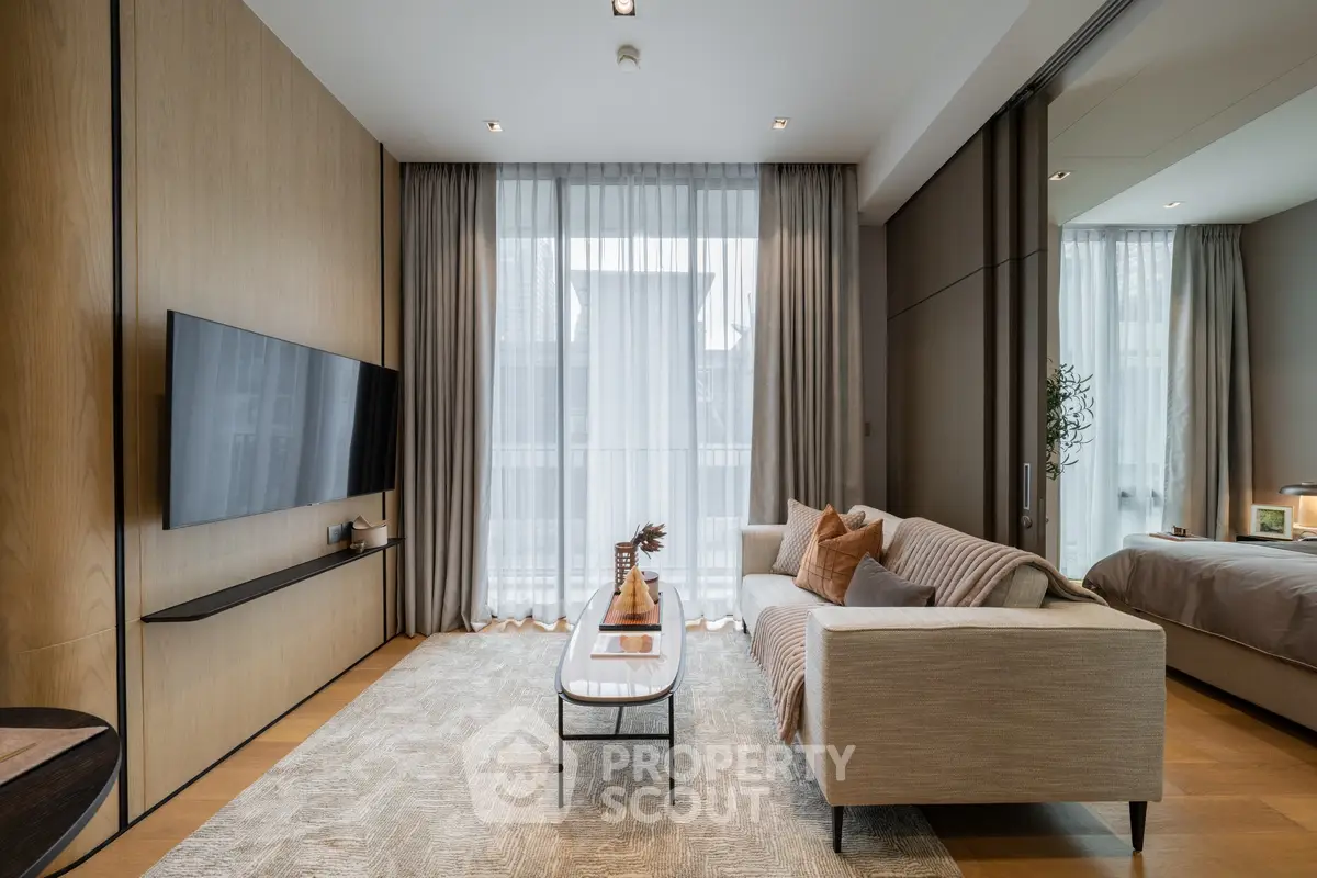 Modern living room with sleek design, large TV, and cozy sofa, perfect for relaxation and entertainment.