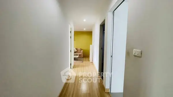 Bright hallway leading to a cozy living area with modern decor
