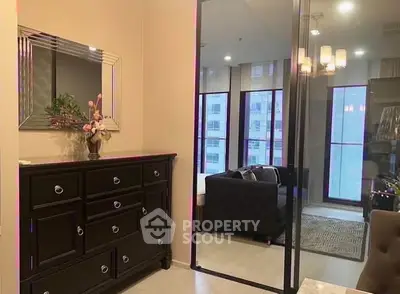 Elegant bedroom with mirrored wardrobe and stylish decor in modern apartment.