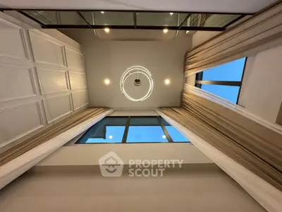 Stunning high-ceiling interior with modern lighting and large windows