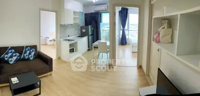 Modern open-plan living room with kitchen and balcony view