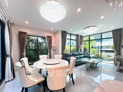 Luxurious living room with elegant dining area and large windows offering garden views.