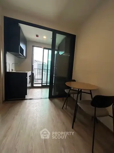 Modern compact kitchen with open layout and balcony view