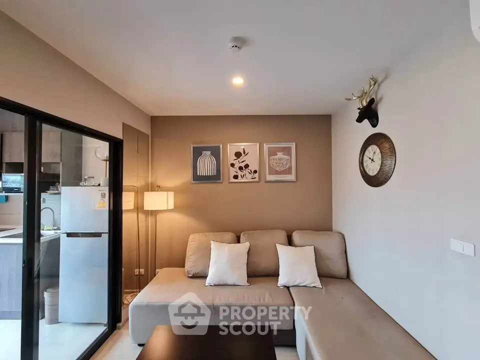 Modern living room with cozy beige sofa and stylish decor in a contemporary apartment.