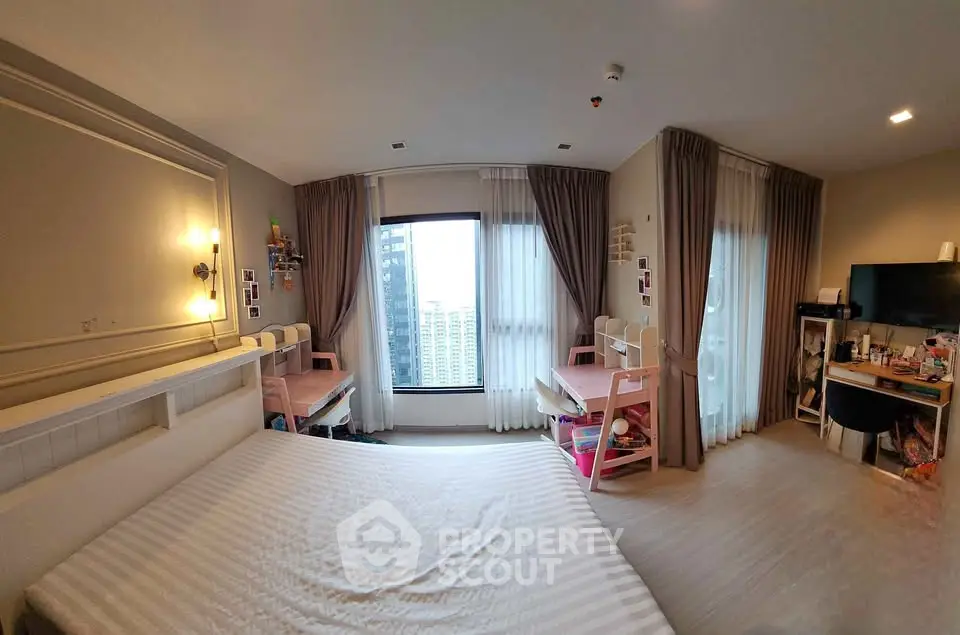 Spacious bedroom with city view and modern decor