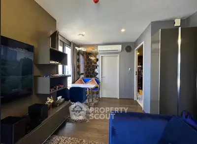 Modern living room with stylish decor and cozy seating area, featuring a sleek entertainment setup.