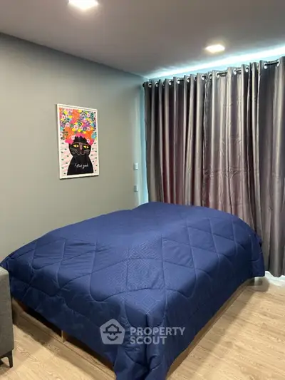 Cozy bedroom with modern decor and blue bedding