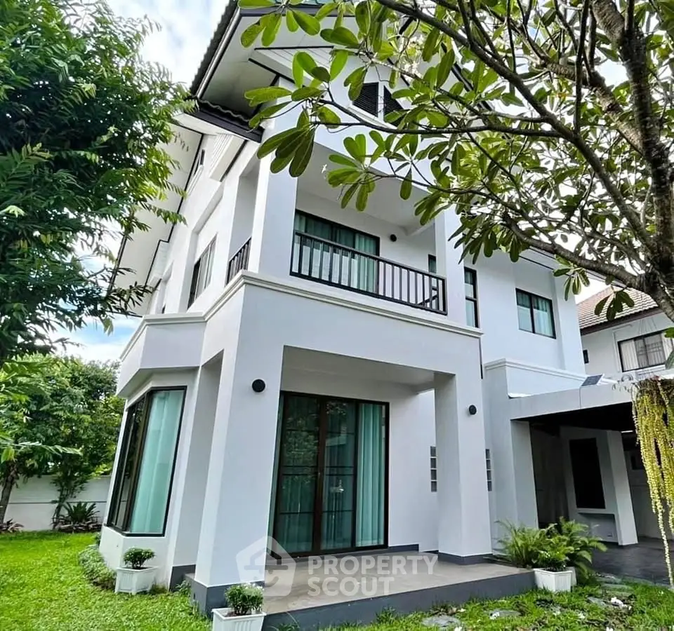 Elegant two-story modern home with lush garden and large windows, perfect for family living.