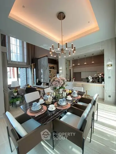 Luxurious open-plan living and dining area with elegant decor and modern kitchen.