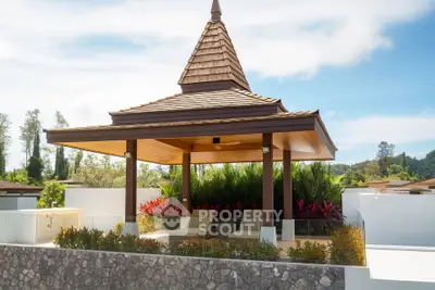 Luxurious outdoor gazebo with lush landscaping and modern design in a serene setting.