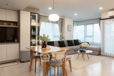 Modern open-plan living room with stylish dining area and cozy corner sofa.