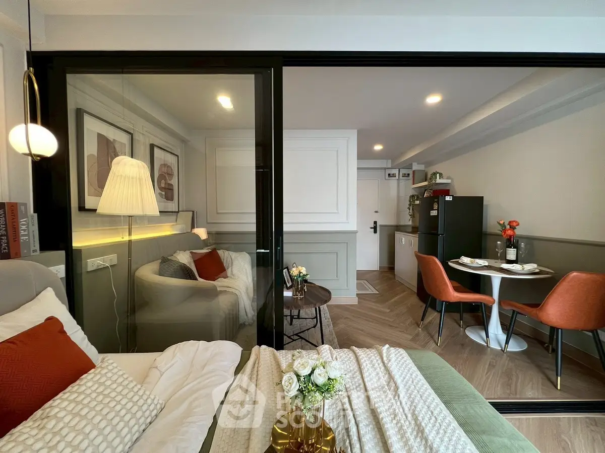 Modern studio apartment with cozy living area and stylish dining space