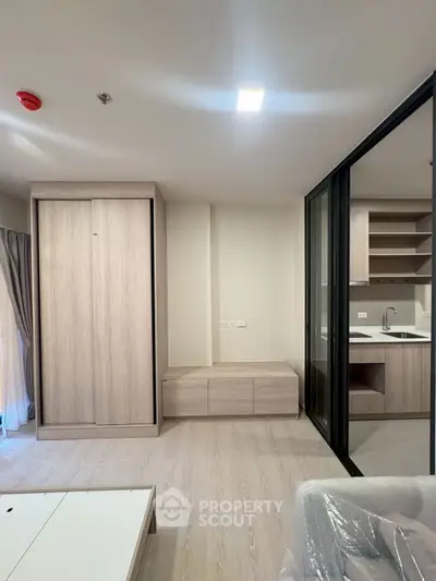 Modern apartment interior with sleek kitchen and stylish wooden cabinetry