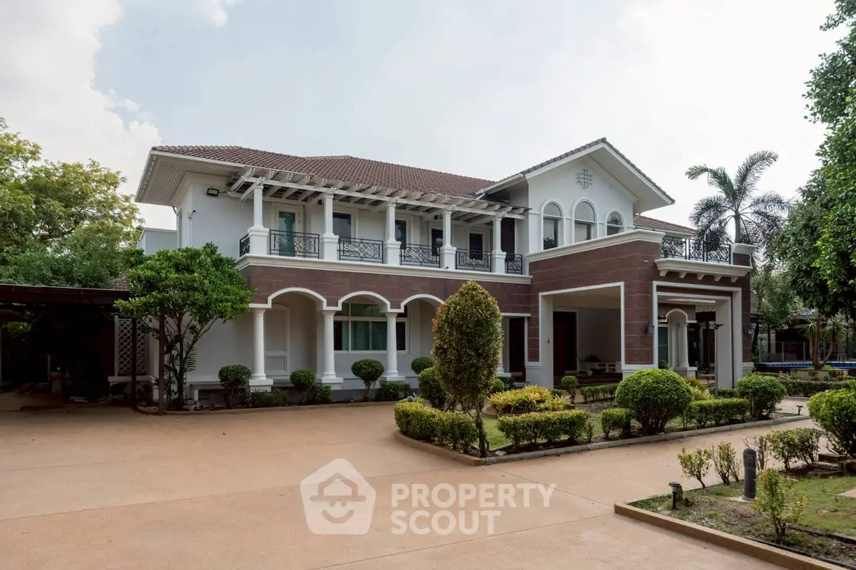 Elegant two-story house with lush garden and spacious driveway