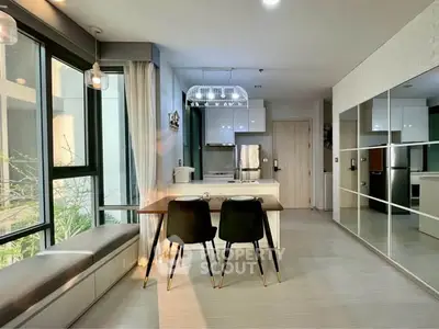 Modern kitchen with open layout, sleek design, and ample natural light in a stylish apartment.