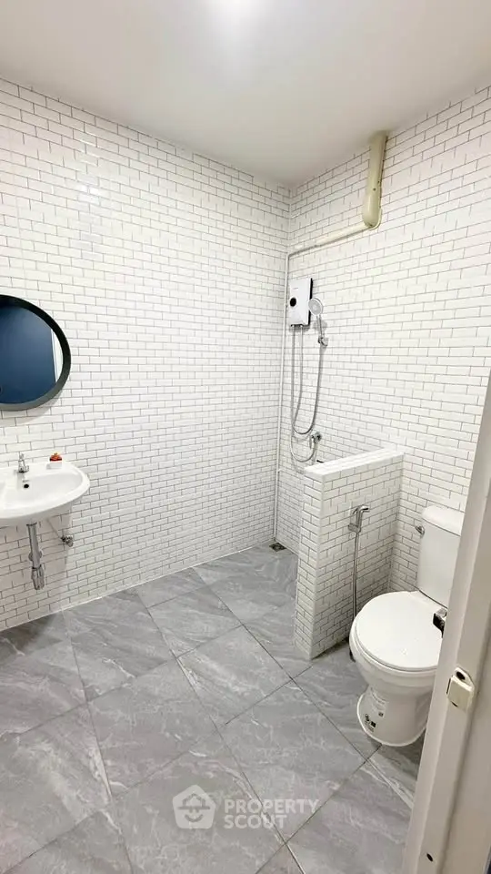 Modern bathroom with white subway tiles and sleek fixtures