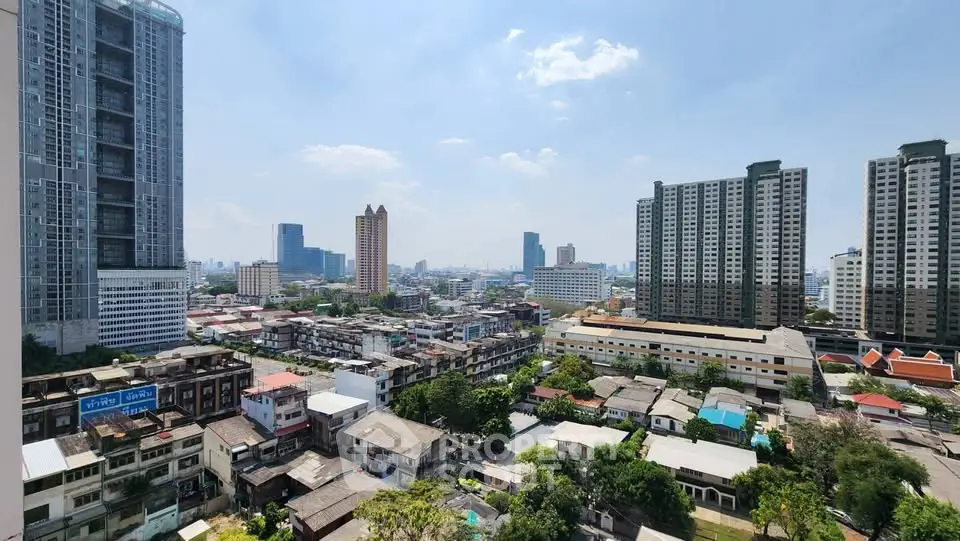 Stunning cityscape view from high-rise building showcasing urban skyline and residential areas.
