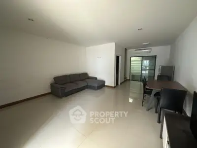 Spacious living room with modern furniture and sleek flooring in a contemporary apartment.