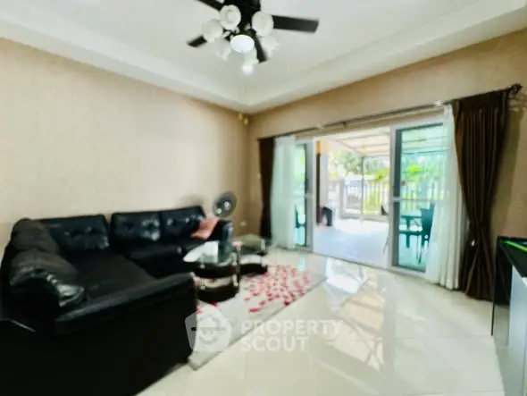 Spacious living room with modern decor and large sliding doors to patio.
