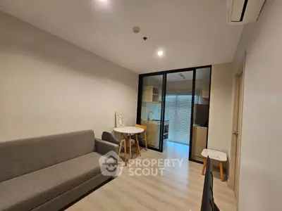 Modern living room with sleek furniture and open kitchen layout