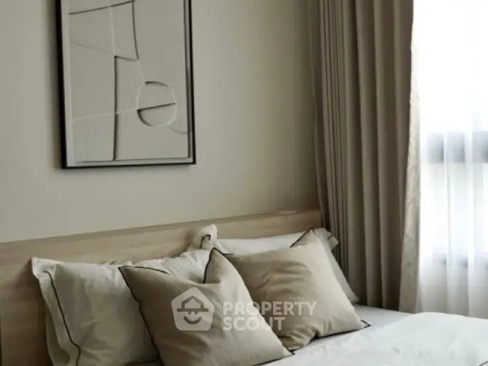 Elegant bedroom with neutral tones and modern decor, featuring a cozy bed and stylish wall art.