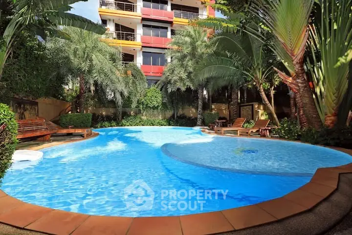 Luxurious apartment complex with stunning pool and lush greenery
