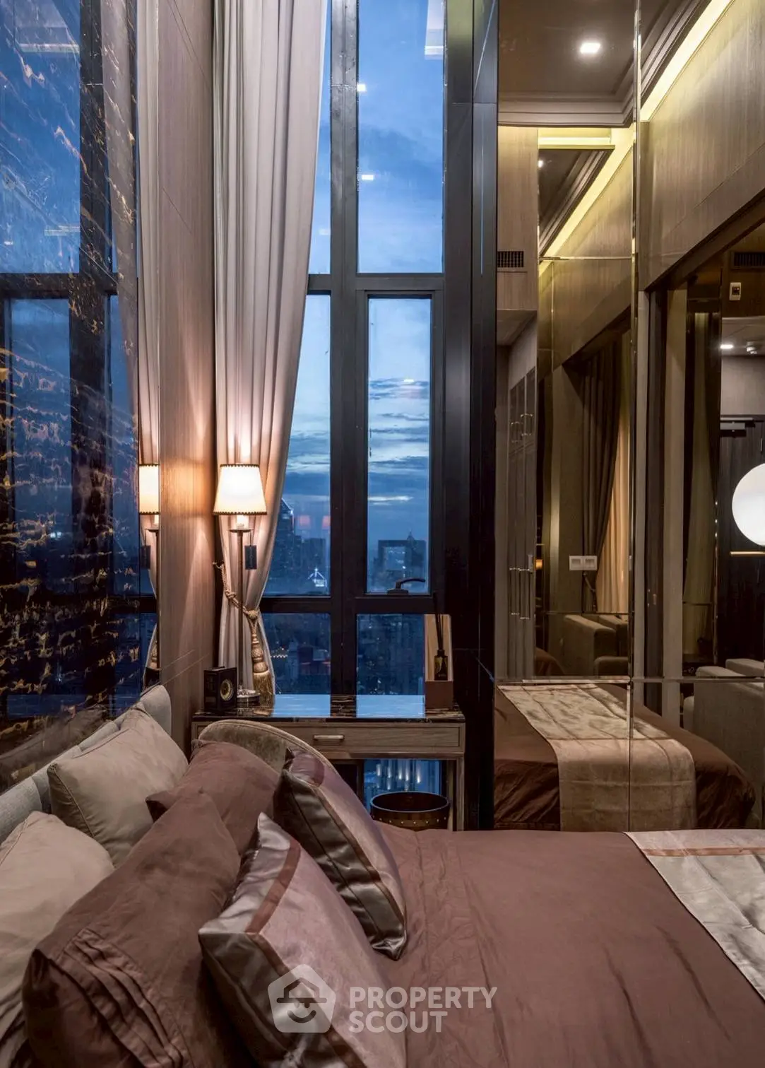 Luxurious bedroom with floor-to-ceiling windows and stunning city view