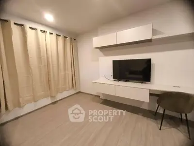 Modern living room with sleek TV setup and elegant curtains