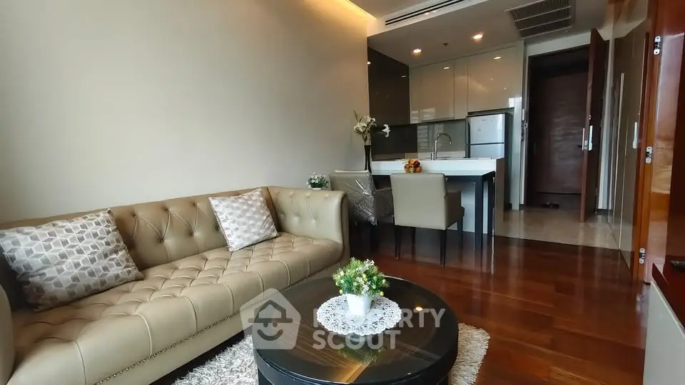 Modern living room with elegant sofa and open kitchen layout in a stylish apartment.