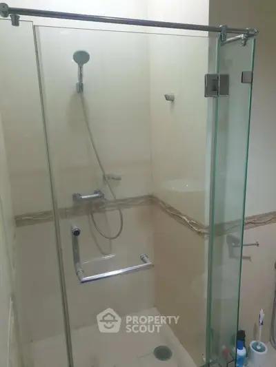 Modern bathroom with glass shower enclosure and sleek fixtures.