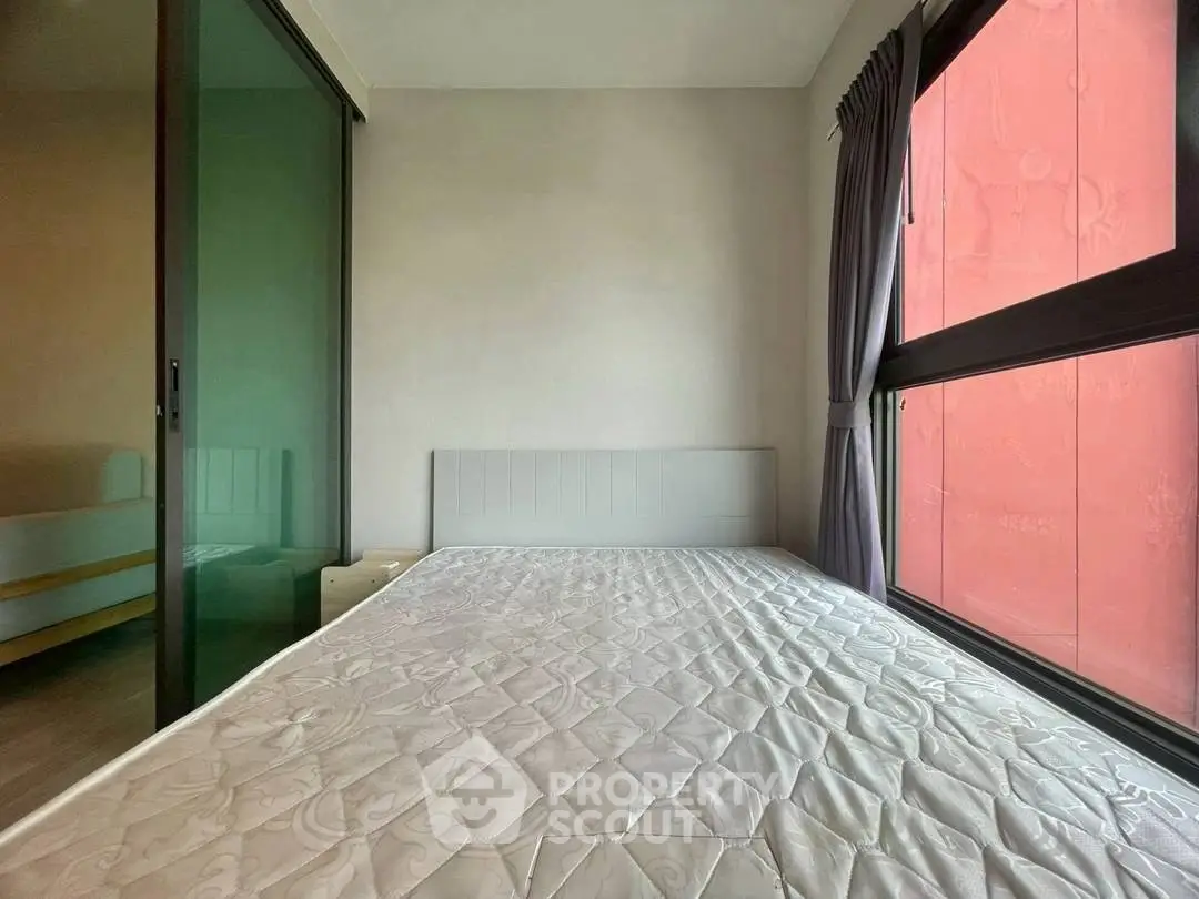 Spacious bedroom with large window and modern design