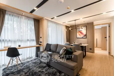 Modern living room with stylish decor and large windows in a contemporary apartment.