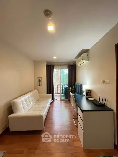 Modern living room with sleek furniture and balcony view in a stylish apartment.