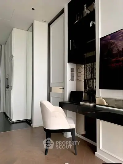 Modern study area with sleek black desk and elegant chair in luxury apartment.
