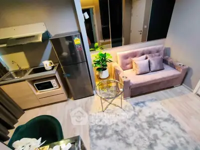 Modern compact living room with kitchenette, featuring cozy sofa, stylish decor, and efficient appliances.