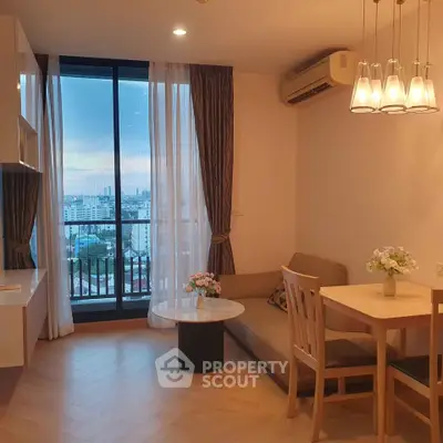 Chic living room with city view, cozy seating, and elegant lighting in modern apartment.