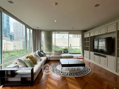 Luxurious corner unit living room with floor-to-ceiling windows and city views.