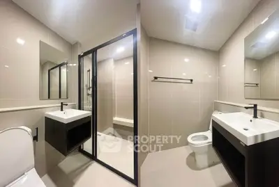Modern bathroom with sleek fixtures and glass shower enclosure