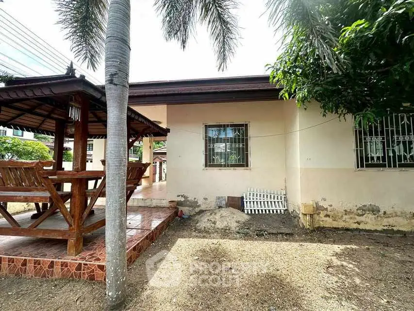 Charming outdoor area with gazebo and garden space in a suburban home.