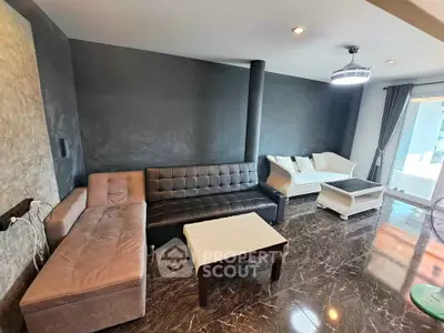 Spacious modern living room with elegant marble flooring and stylish furniture.