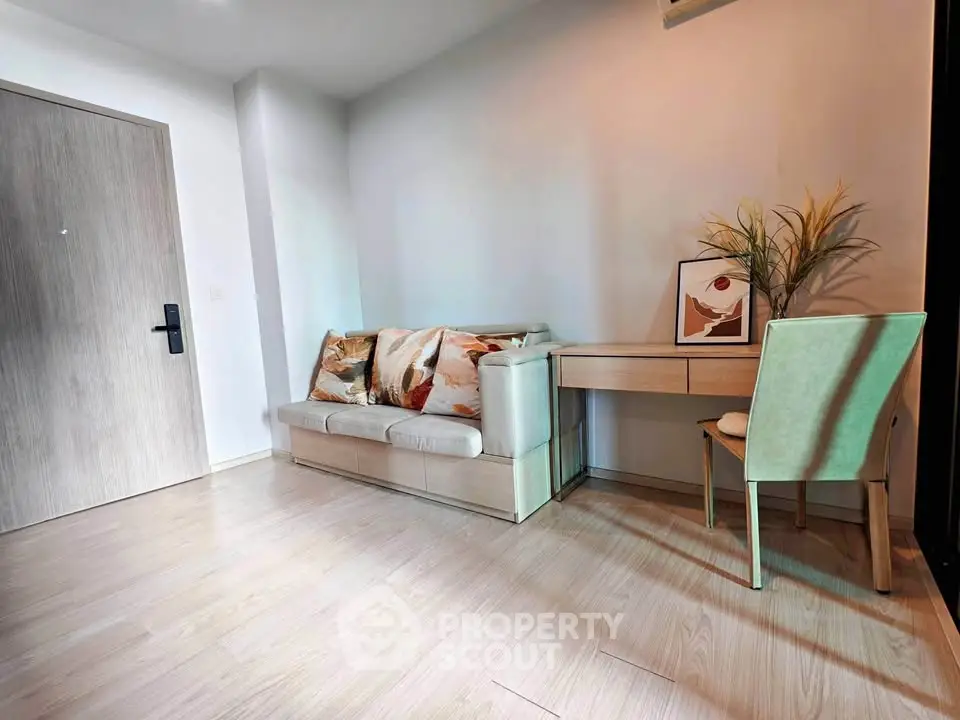 Modern living room with stylish sofa and desk, perfect for a cozy home office setup.