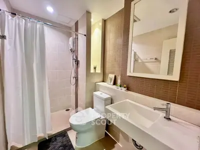 Modern bathroom with sleek fixtures and spacious shower area