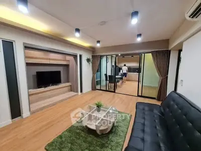 Spacious modern living room with sleek design and open layout, featuring a cozy seating area and stylish decor.
