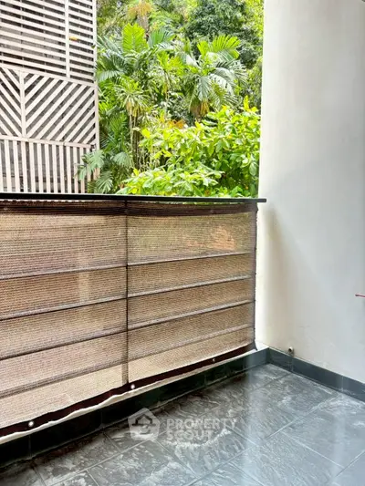 Charming balcony with lush greenery view and modern railing design