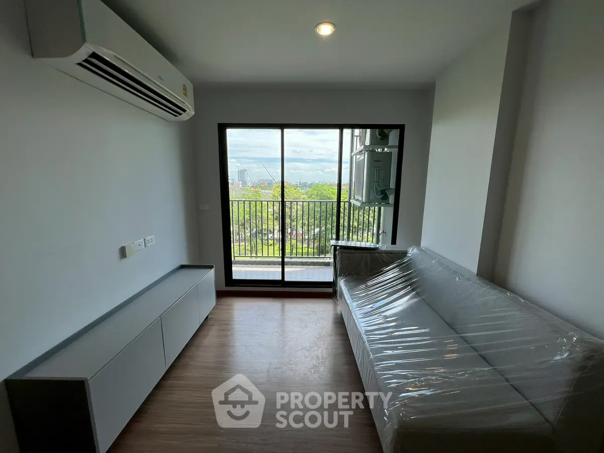 Modern living room with balcony view and air conditioning in a stylish apartment.