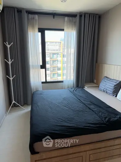 Modern bedroom with large window and stylish decor in urban apartment