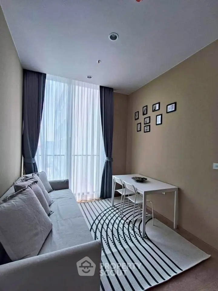 Modern living room with stylish decor and natural light in a cozy apartment.