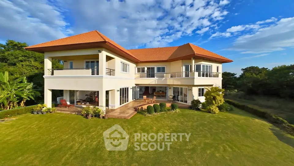 Stunning two-story villa with lush garden and spacious terrace, perfect for luxury living in a serene environment.