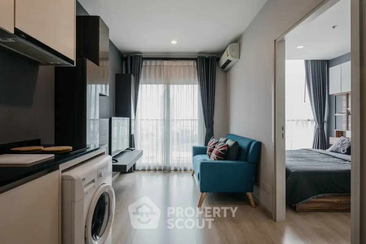 Modern apartment interior with open layout, featuring a cozy living room and adjacent bedroom.
